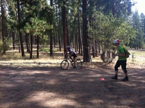 Evergreen East mtb instructor, Kyle, gives pointer to a student during a mountain biking class.
